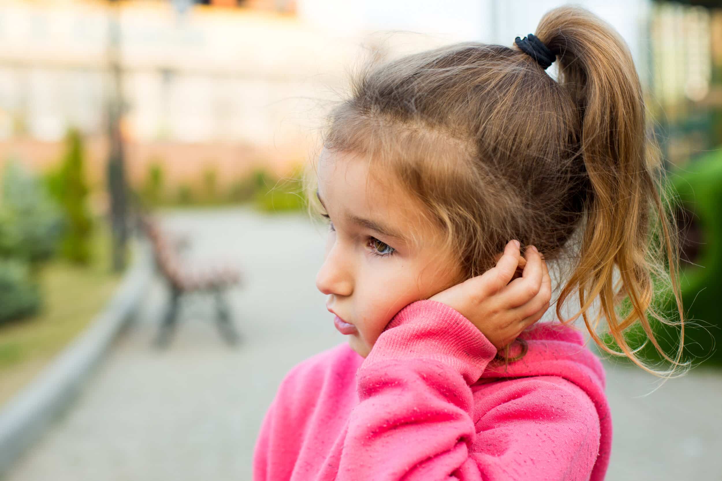 A child holding her ear because of an ear infection